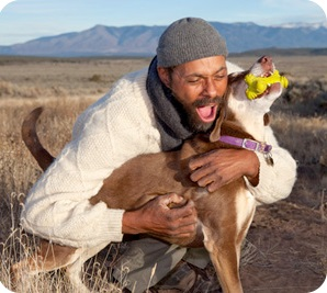 Adult hugging his dog.
